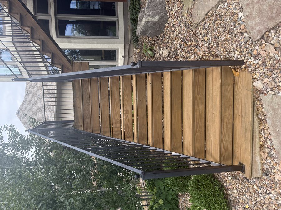 Same wood staircase restored with rich brown stain after Elite Pressure Pros staining