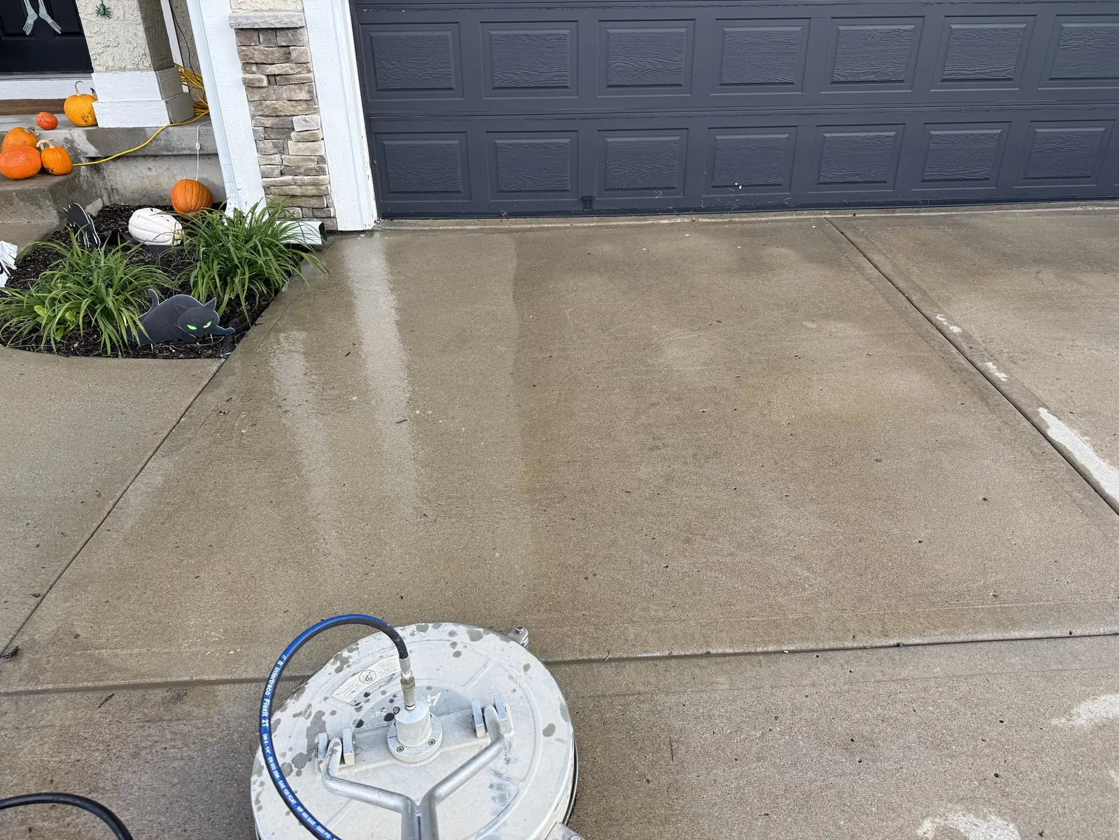 Surface cleaner leaving a clean line across a Northland driveway
