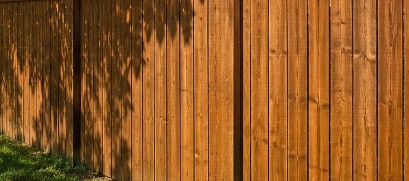 Same wood fence restored and freshly stained after Elite Pressure Pros cleaning and staining