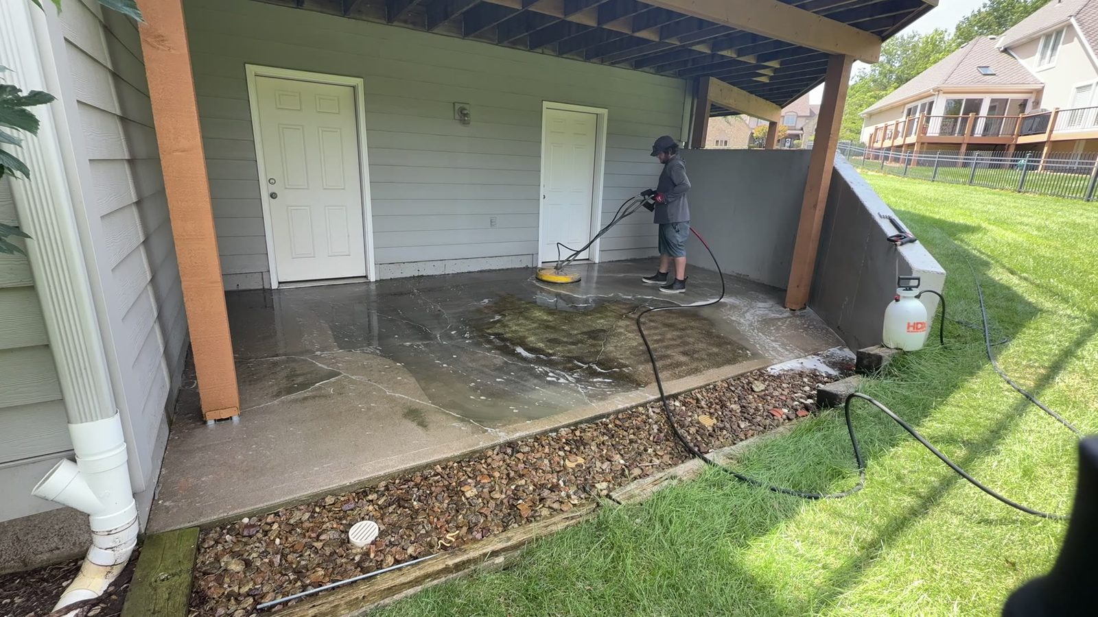 Elite Pressure Pros technician soft washing a patio in the Kansas City Northland