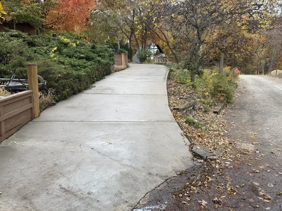 Long driveway after pressure washing under mature trees